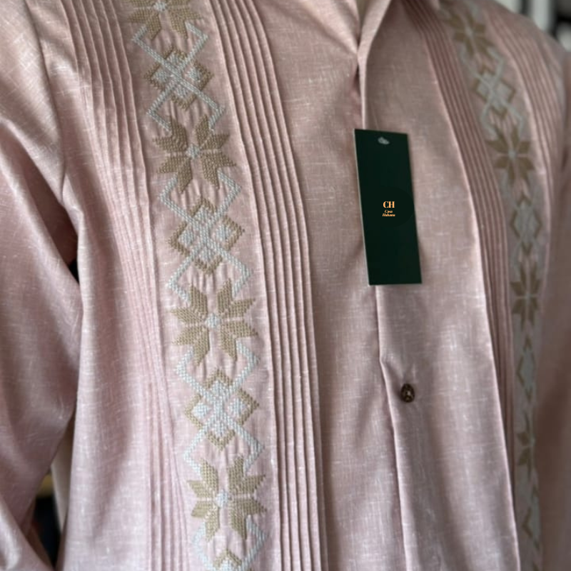 Pink embroidered shirt with a brand tag on a blurred background