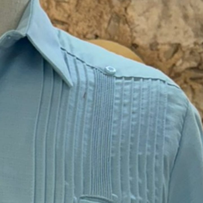 man wearing light blue presidential guayabera